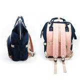 Seitenansicht und Rückansicht vom Wickelrucksack POP von Dokoclub in dunkelblau und rosa